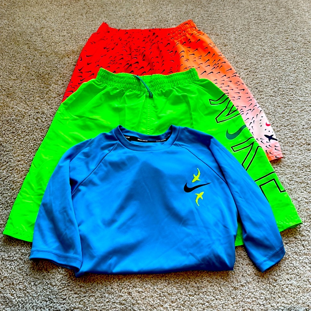 Boys Nike swim trunks and Nike rash guard.   Size L trunks size M shirt